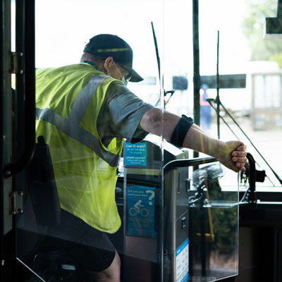 Masked bus driver opening DriverGuard barrier