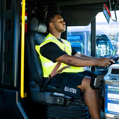 Bus driver looking ahead driving bus